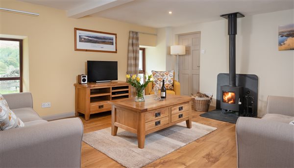 holiday cottage living room with log burner underfloor heating